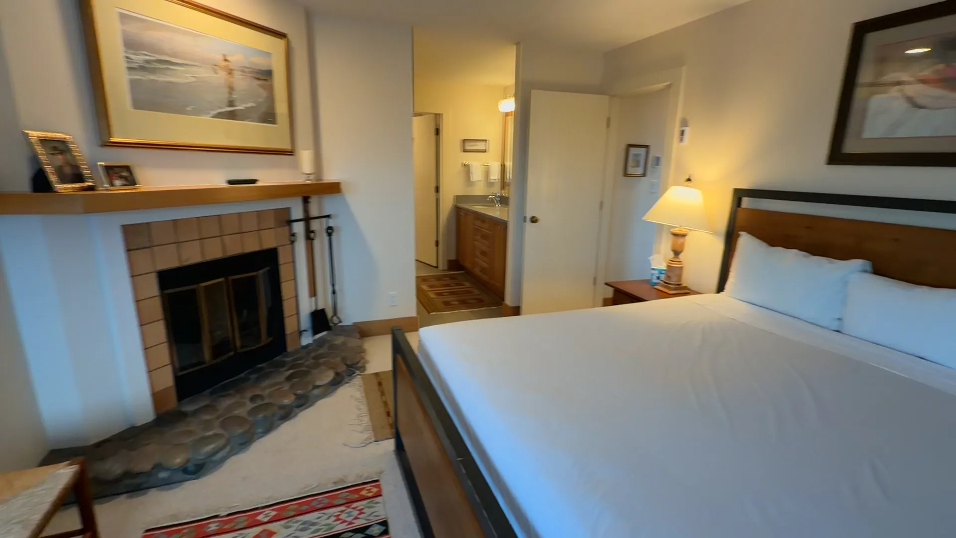 Master bedroom wide view showing king bed, fireplace and ensuite bathroom entry - Spring Creek Ranch Jackson Hole