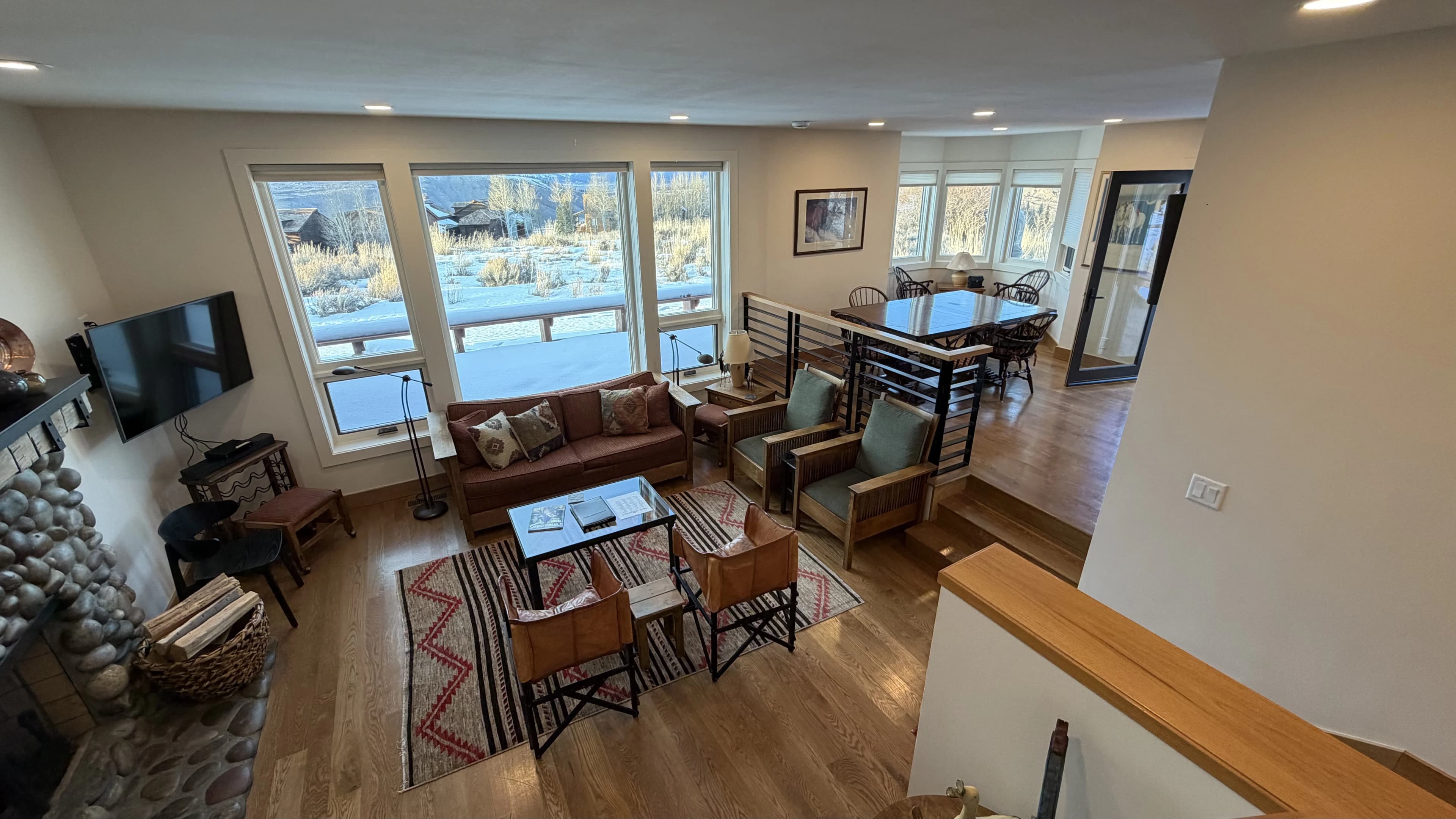 Main living room with river stone fireplace - Spring Creek Ranch townhome Jackson Hole