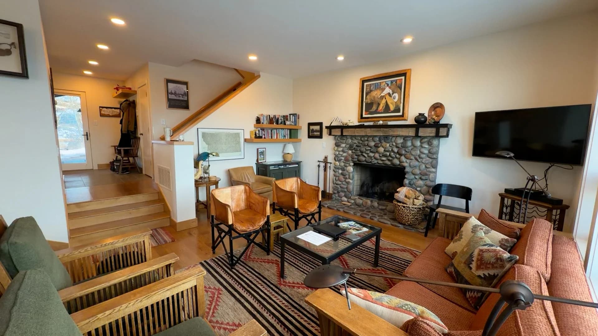 Spring Creek Ranch living room with river stone fireplace and Grand Teton views